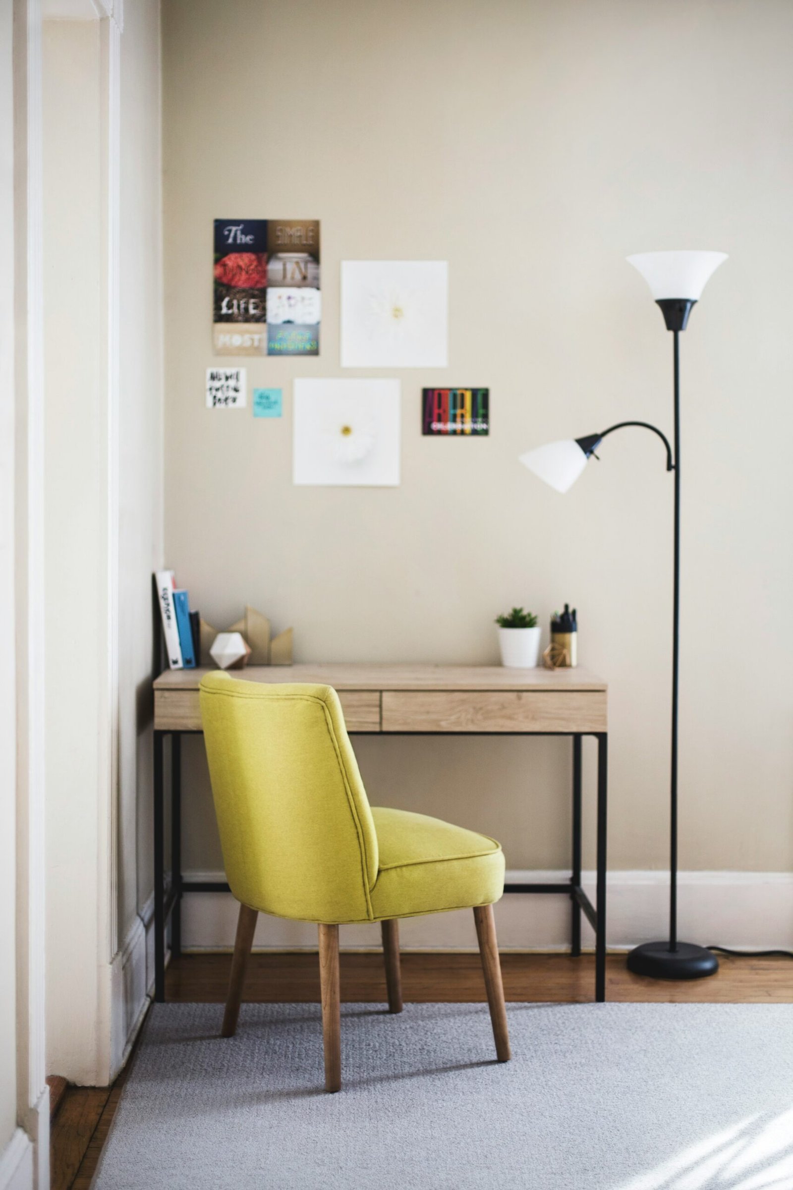 black 2-light torchiere beside brown wooden-top desk with black steel frame